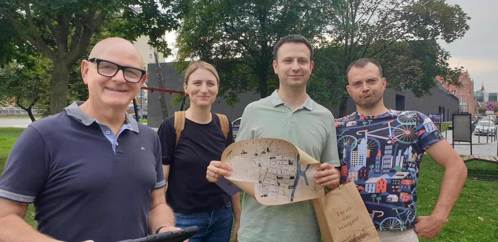 Team holding game map outdoors